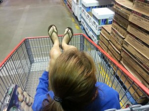 girl riding in shopping cart